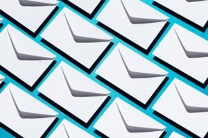 A pattern of white envelopes on a blue background symbolizing email marketing campaigns for Shopify stores using Klaviyo.