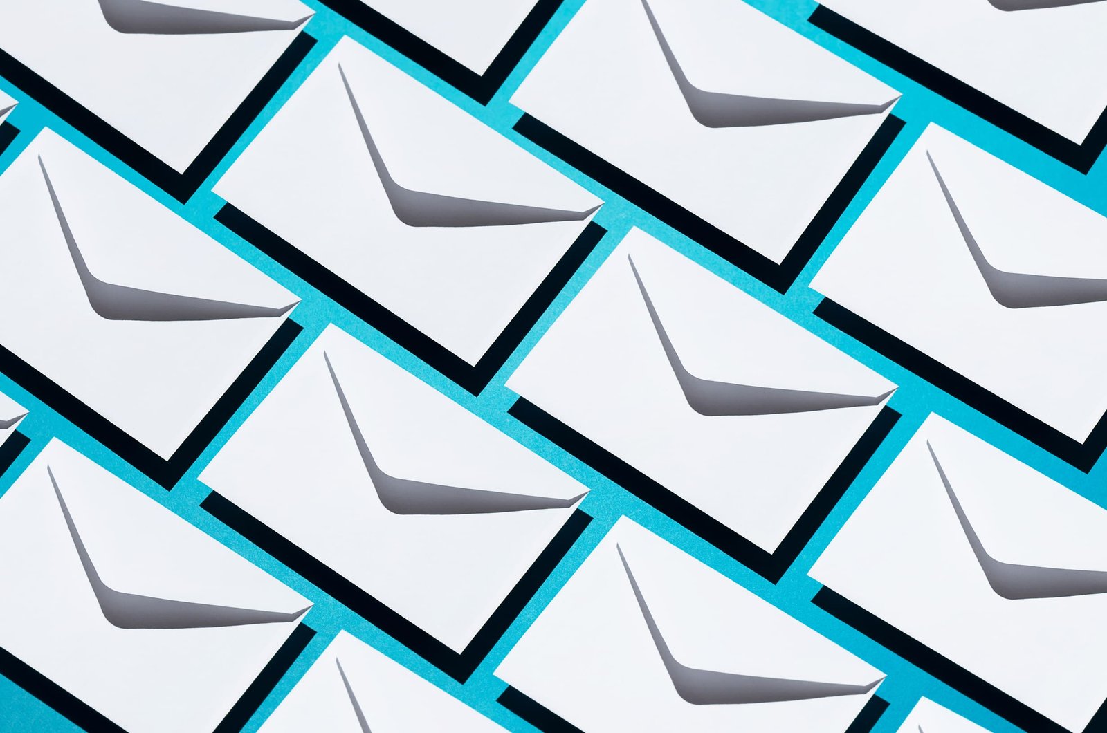 A pattern of white envelopes on a blue background symbolizing email marketing campaigns for Shopify stores using Klaviyo.